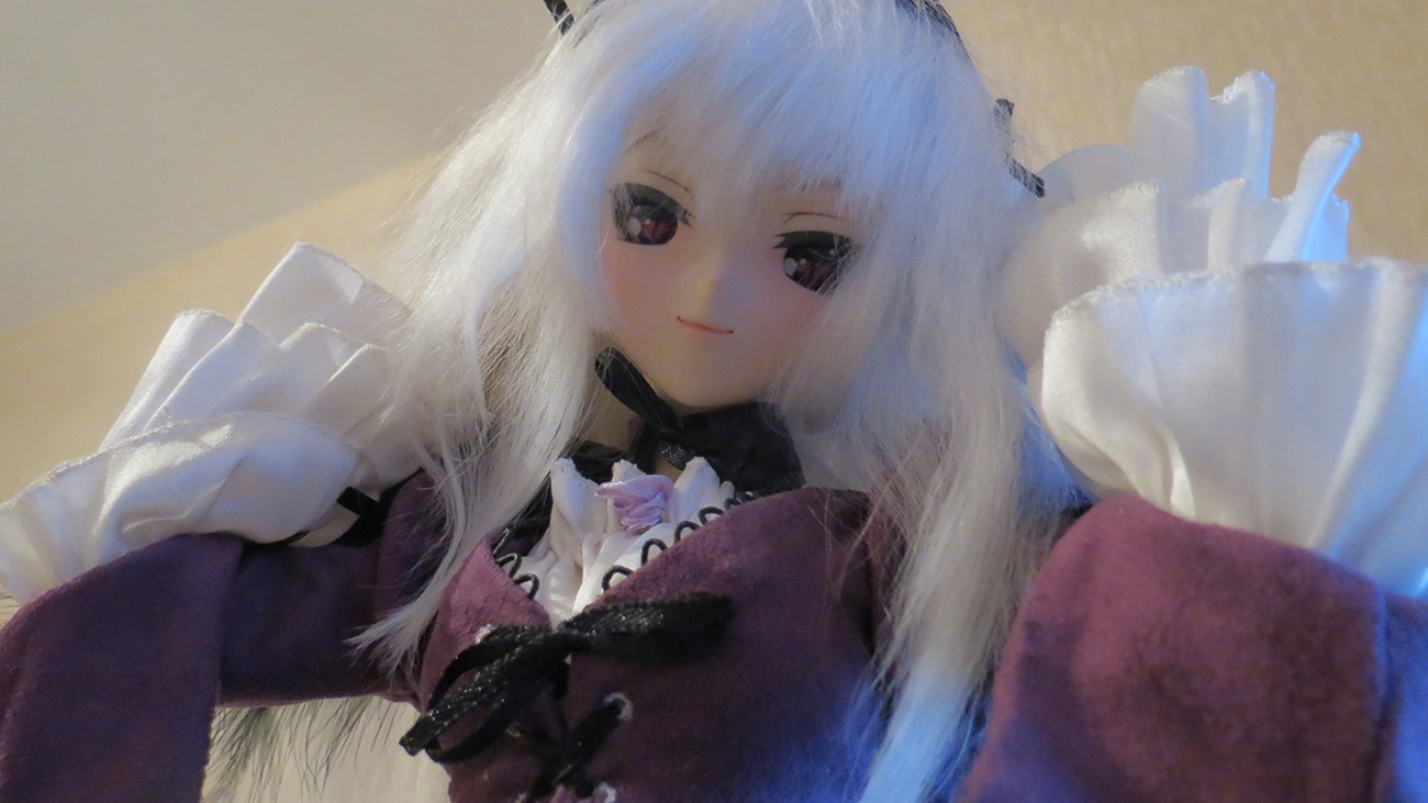 1girl bangs bow closed_mouth doll dress frills long_hair long_sleeves looking_at_viewer photo smile solo suigintou upper_body white_hair
