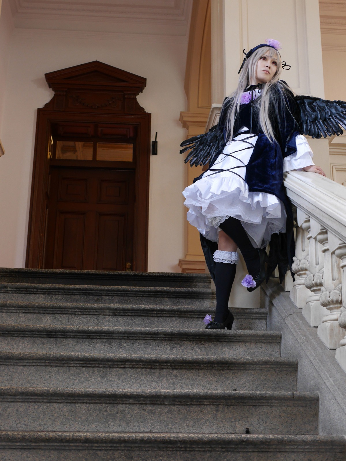 1girl black_legwear boots dress frills indoors long_hair long_sleeves silver_hair sitting solo standing suigintou wings