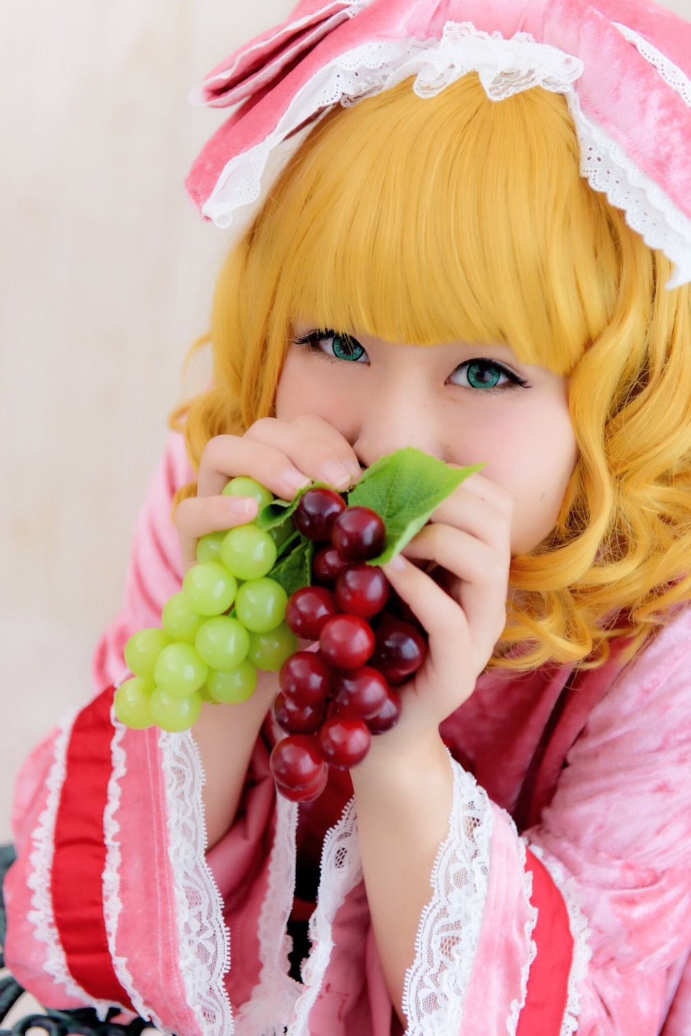 1girl bangs blonde_hair blue_eyes blurry food frills fruit hinaichigo holding holding_food holding_fruit lolita_fashion looking_at_viewer ribbon solo upper_body