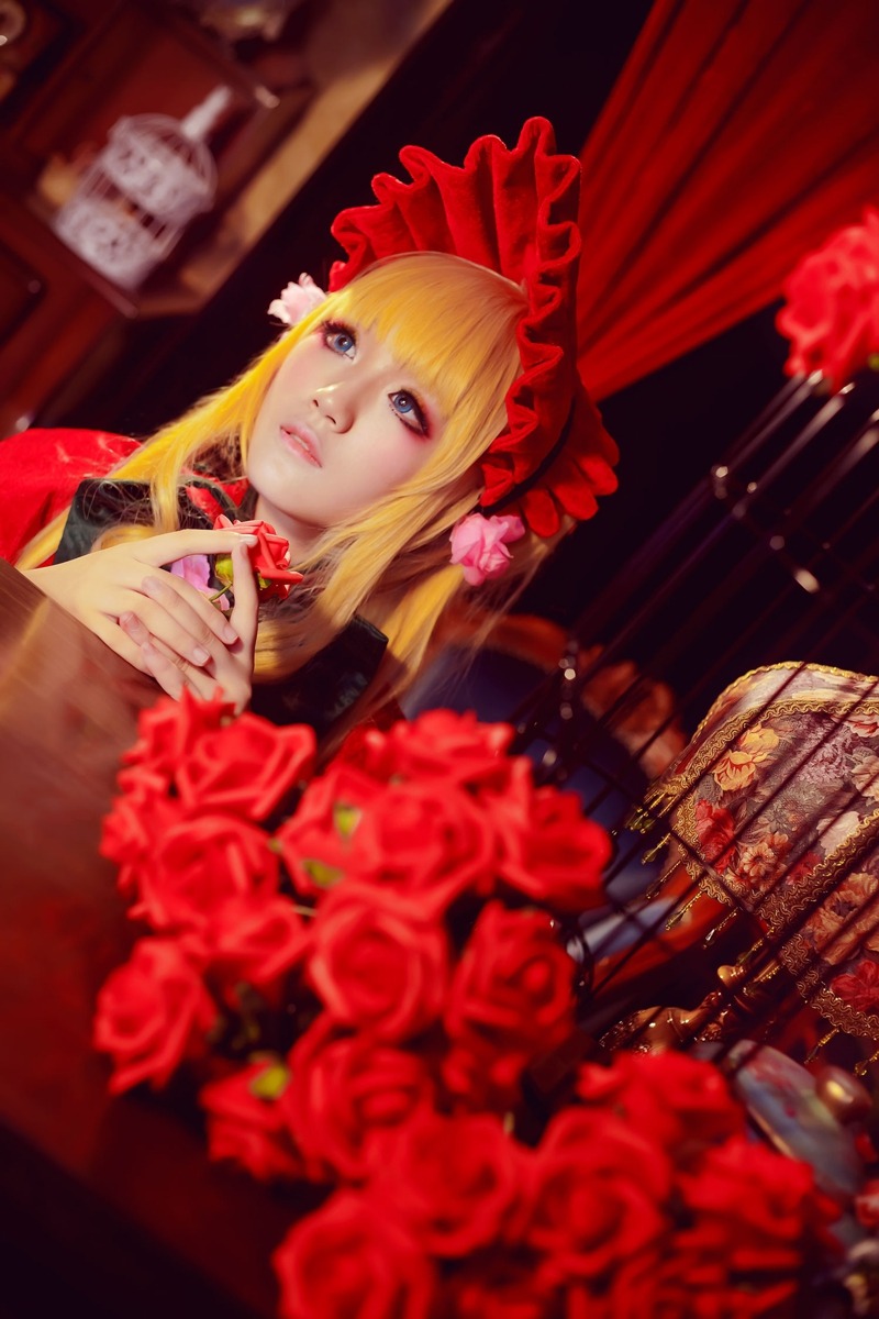 1girl bangs blonde_hair blue_eyes blurry curtains depth_of_field flower indoors lips long_hair looking_at_viewer red_flower red_rose rose shinku solo window