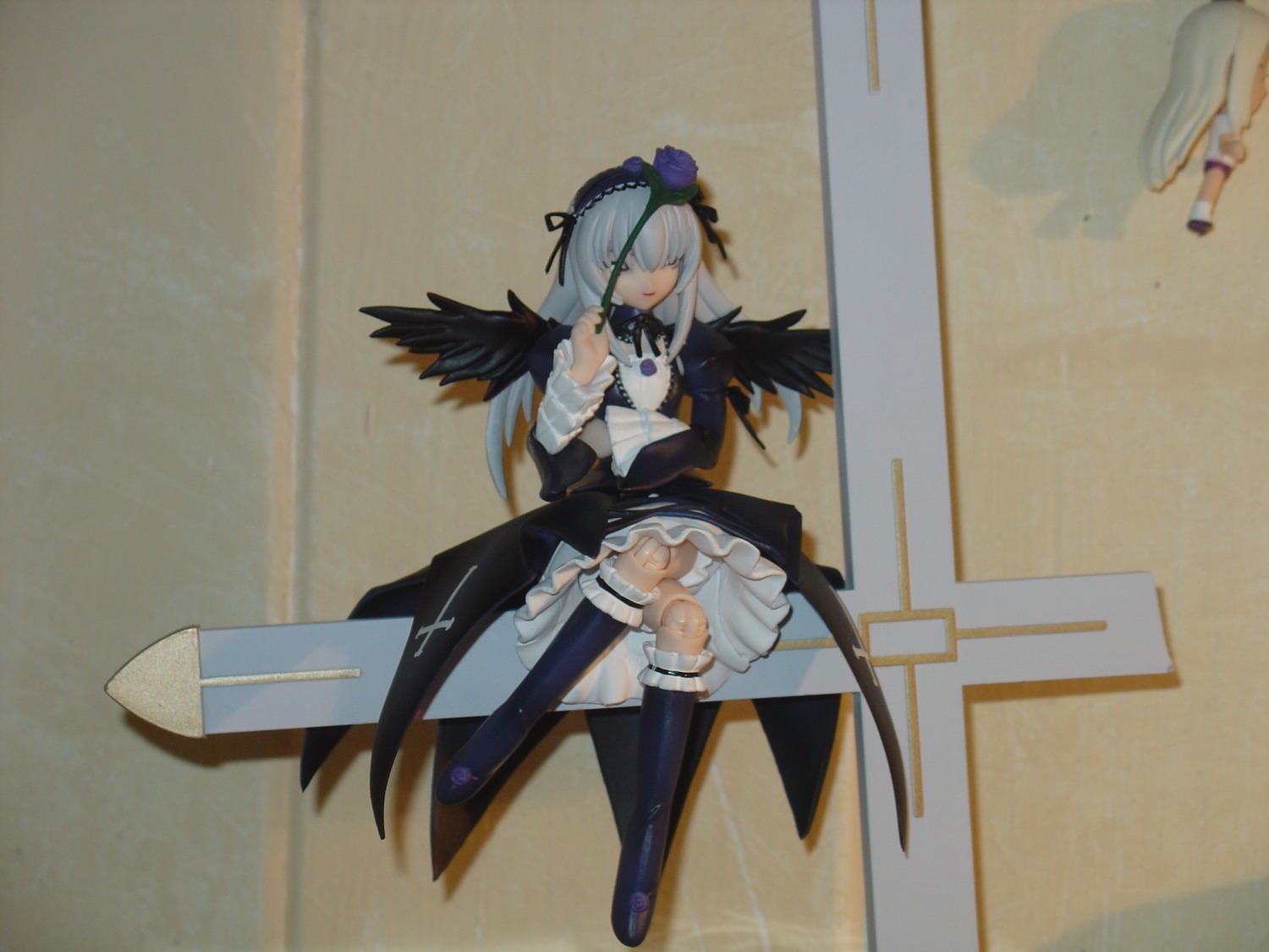 1girl black_wings boots closed_eyes doll dress feathered_wings feathers frills long_hair long_sleeves photo silver_hair sitting solo suigintou thighhighs wings