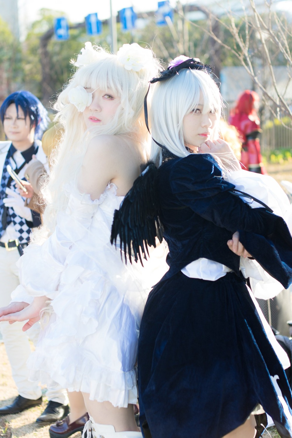2girls 3d blue_hair blurry blurry_background blurry_foreground closed_eyes depth_of_field dress frills long_hair long_sleeves looking_at_viewer multiple_cosplay multiple_girls outdoors photo tagme white_hair wings