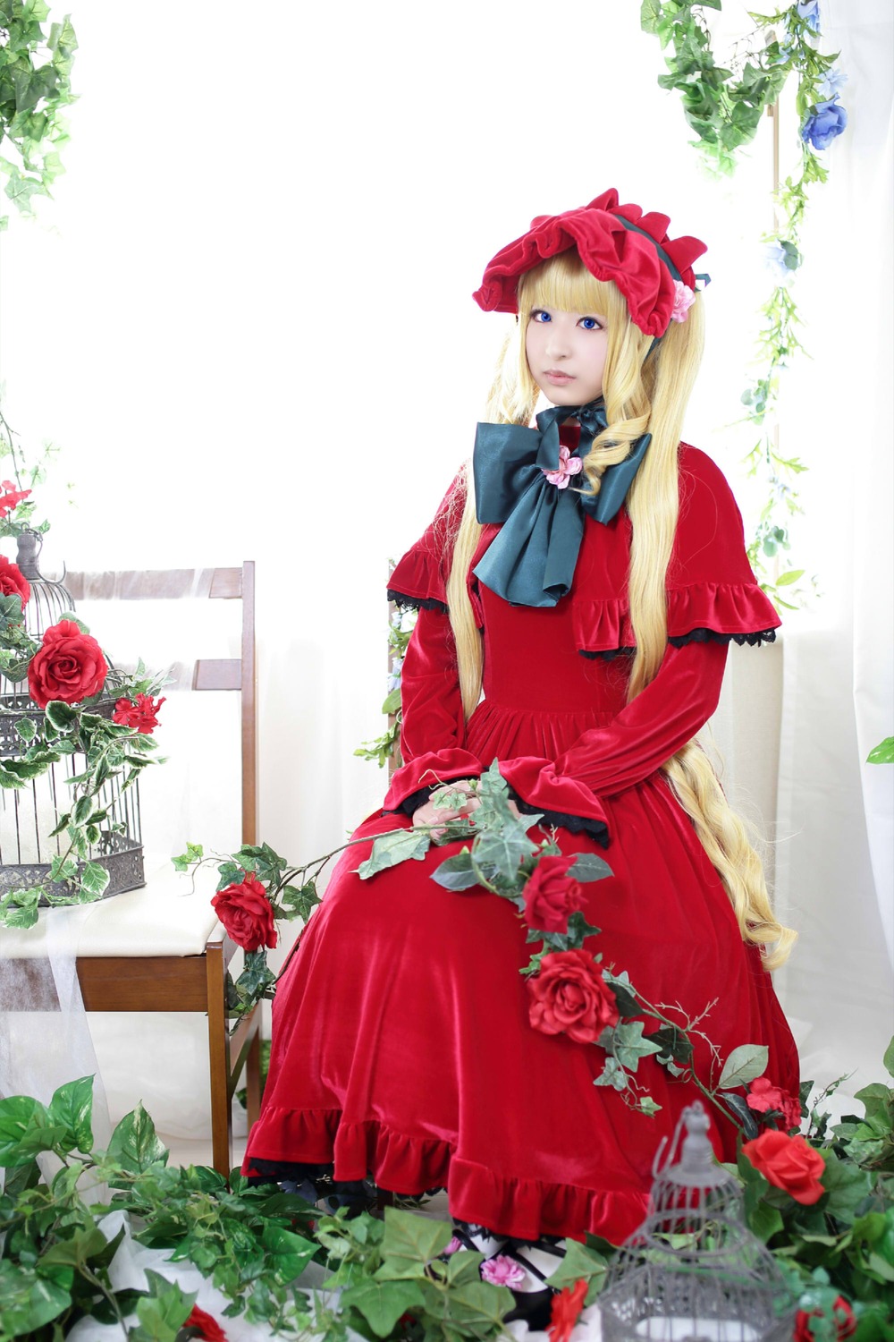 1girl blonde_hair blue_eyes bonnet capelet dress flower long_hair plant red_dress red_flower red_rose rose shinku solo