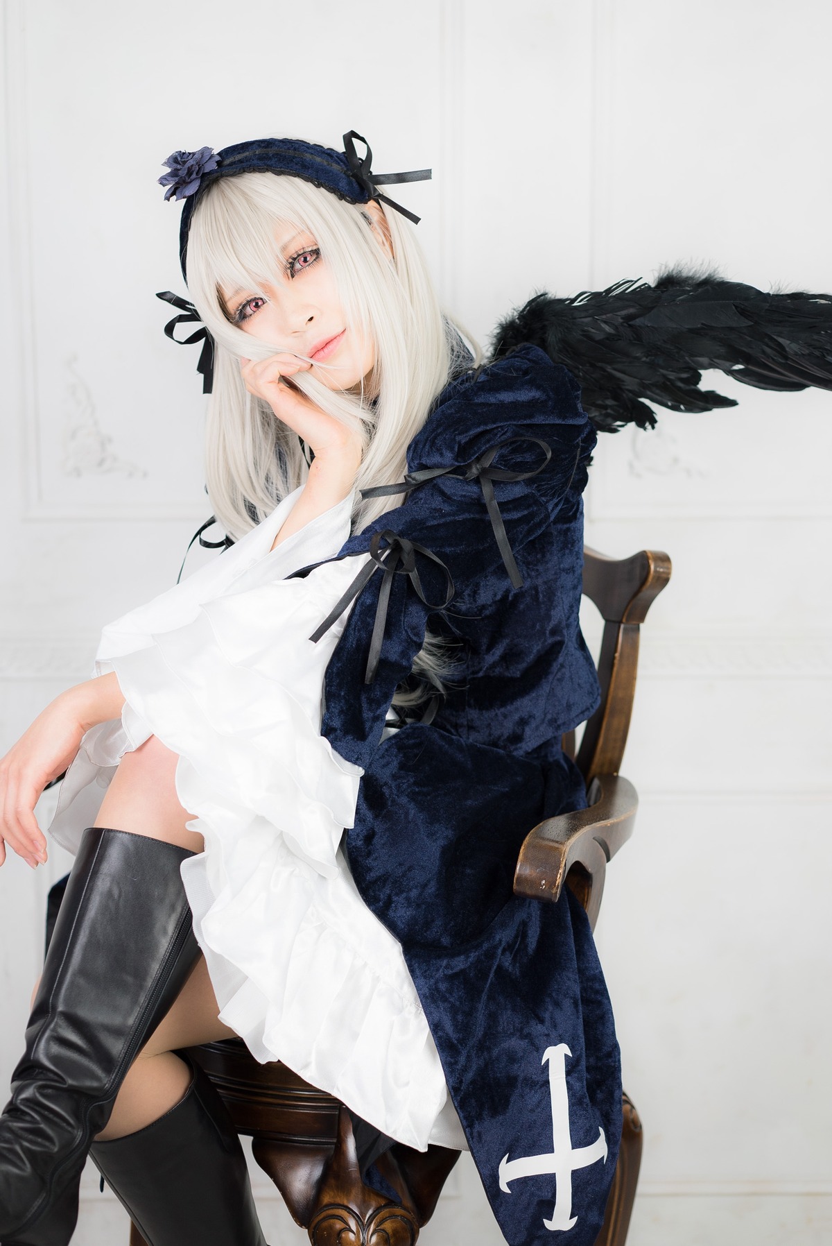 1girl boots dress feathers hairband long_hair long_sleeves looking_at_viewer ribbon sitting solo suigintou weapon wings