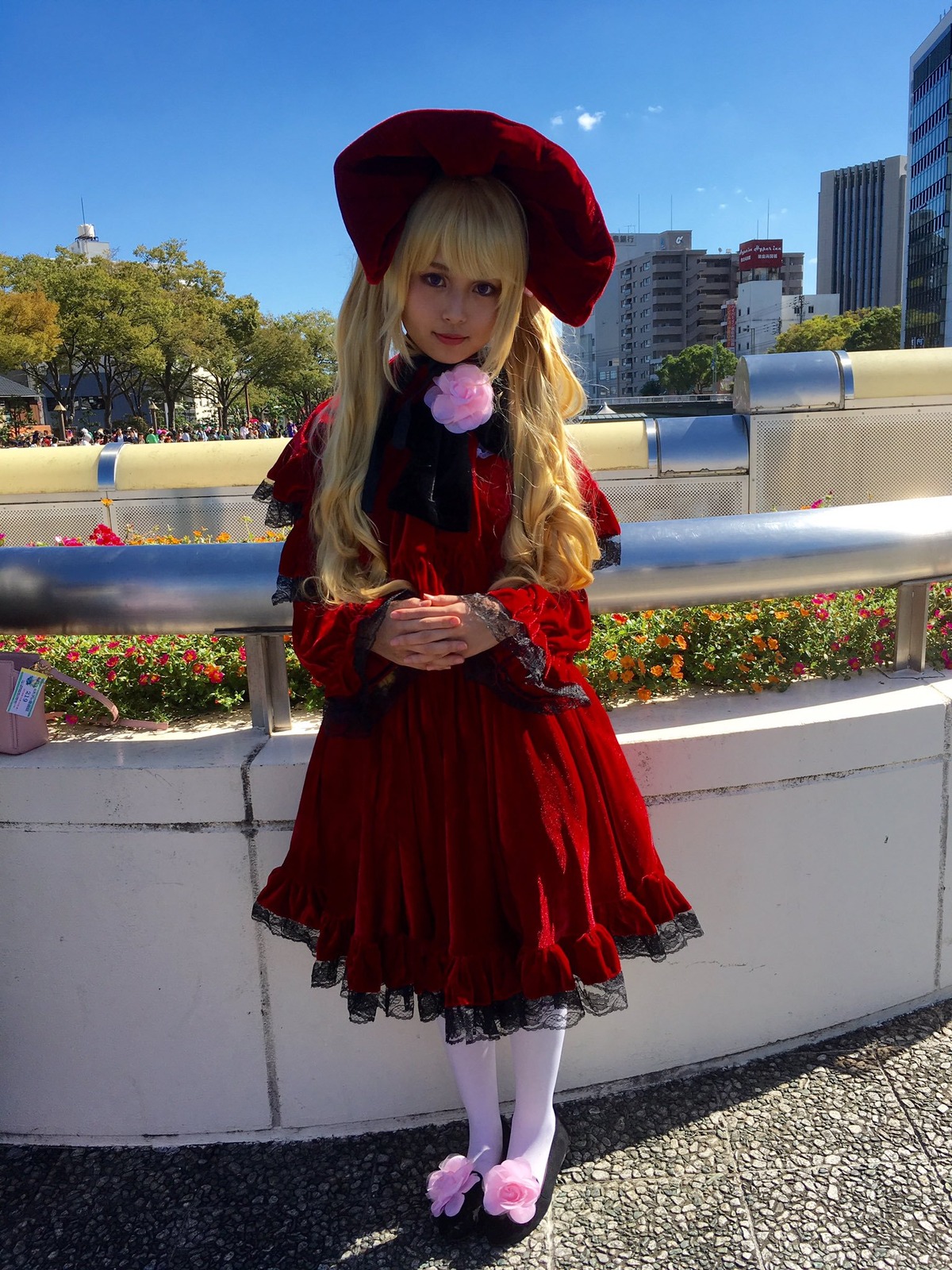 1girl blonde_hair building day dress hat long_hair looking_at_viewer outdoors pantyhose shinku sky smile solo standing