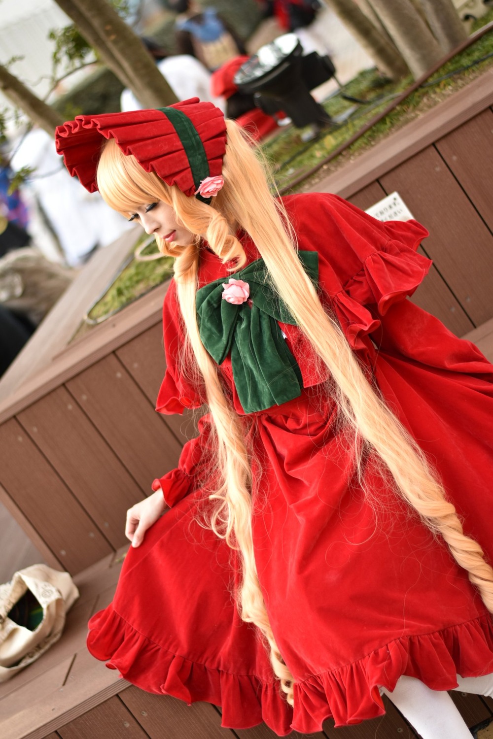 blonde_hair blurry blurry_background blurry_foreground bonnet capelet depth_of_field dress food long_hair long_sleeves multiple_girls pantyhose photo red_dress shinku solo