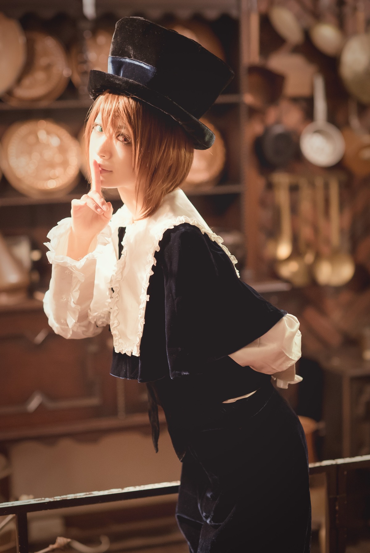 1girl black_headwear blurry blurry_background bob_cut brown_eyes brown_hair capelet depth_of_field finger_to_mouth hat indoors lips looking_at_viewer short_hair skirt solo souseiseki standing top_hat