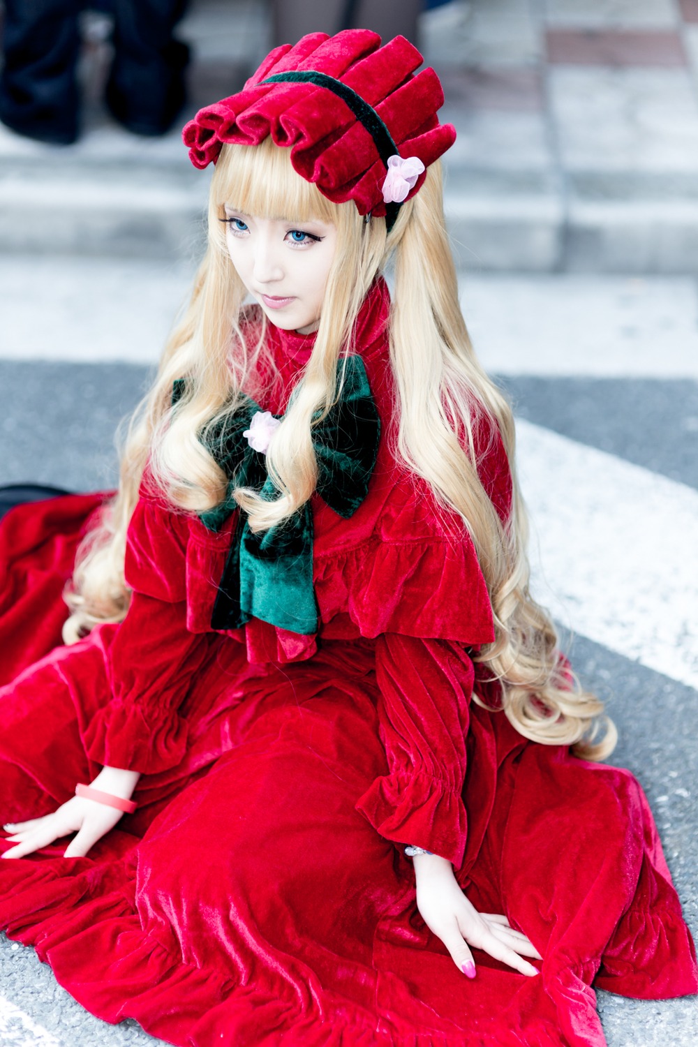 1girl bangs blonde_hair blue_eyes blurry blurry_background blurry_foreground depth_of_field dress long_hair long_sleeves photo red_dress shinku sitting solo