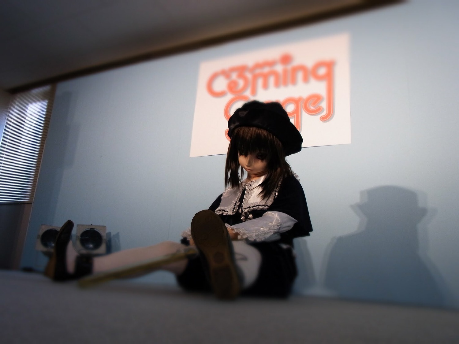 1girl black_hair blurry blurry_background blurry_foreground depth_of_field hat indoors instrument long_sleeves necklace photo sitting solo souseiseki