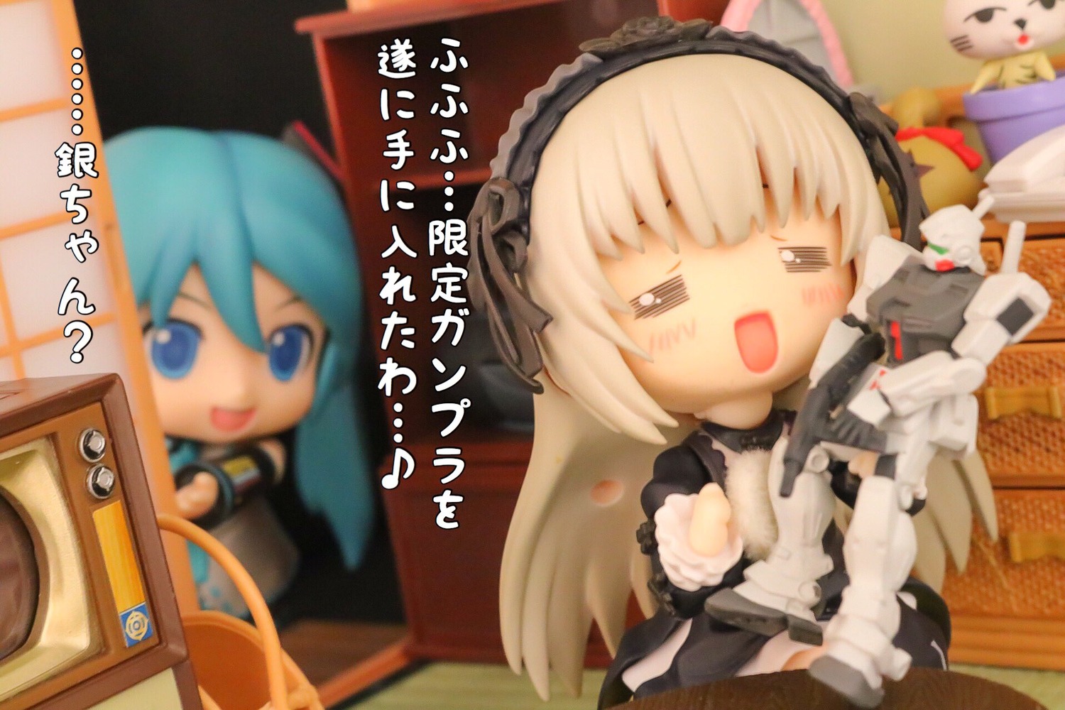 2girls blue_eyes blue_hair blurry blurry_foreground blush chibi depth_of_field doll figure food lolita_hairband long_hair multiple_girls photo solo suigintou