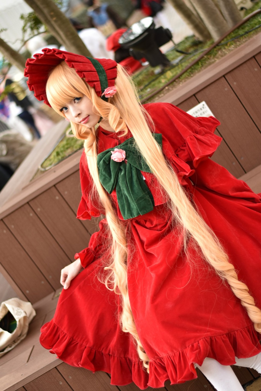 blonde_hair blurry blurry_background blurry_foreground bonnet bow depth_of_field dress food long_hair long_sleeves multiple_girls pantyhose photo red_dress ribbon shinku sitting solo wooden_floor