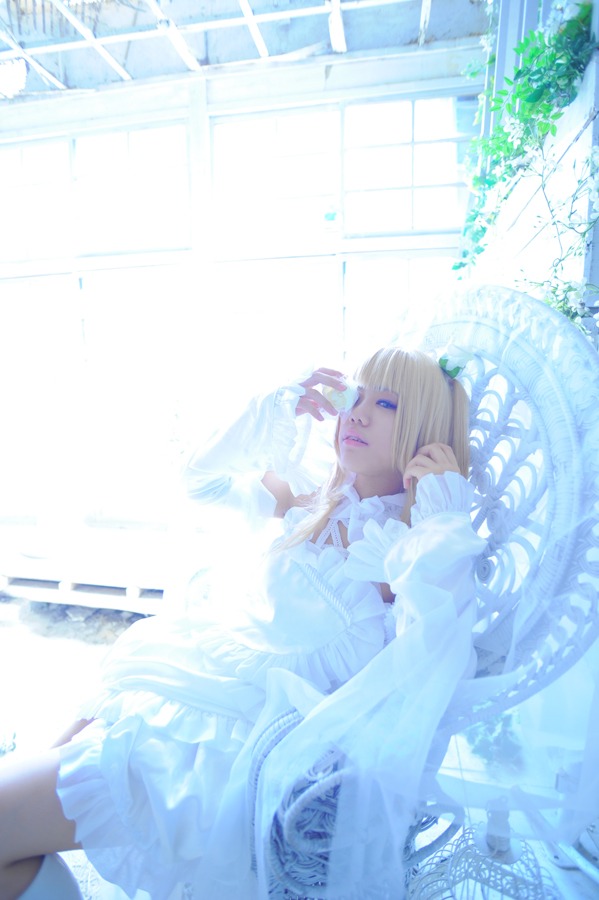 1girl blonde_hair blue_eyes blurry depth_of_field dress frills kirakishou lying solo