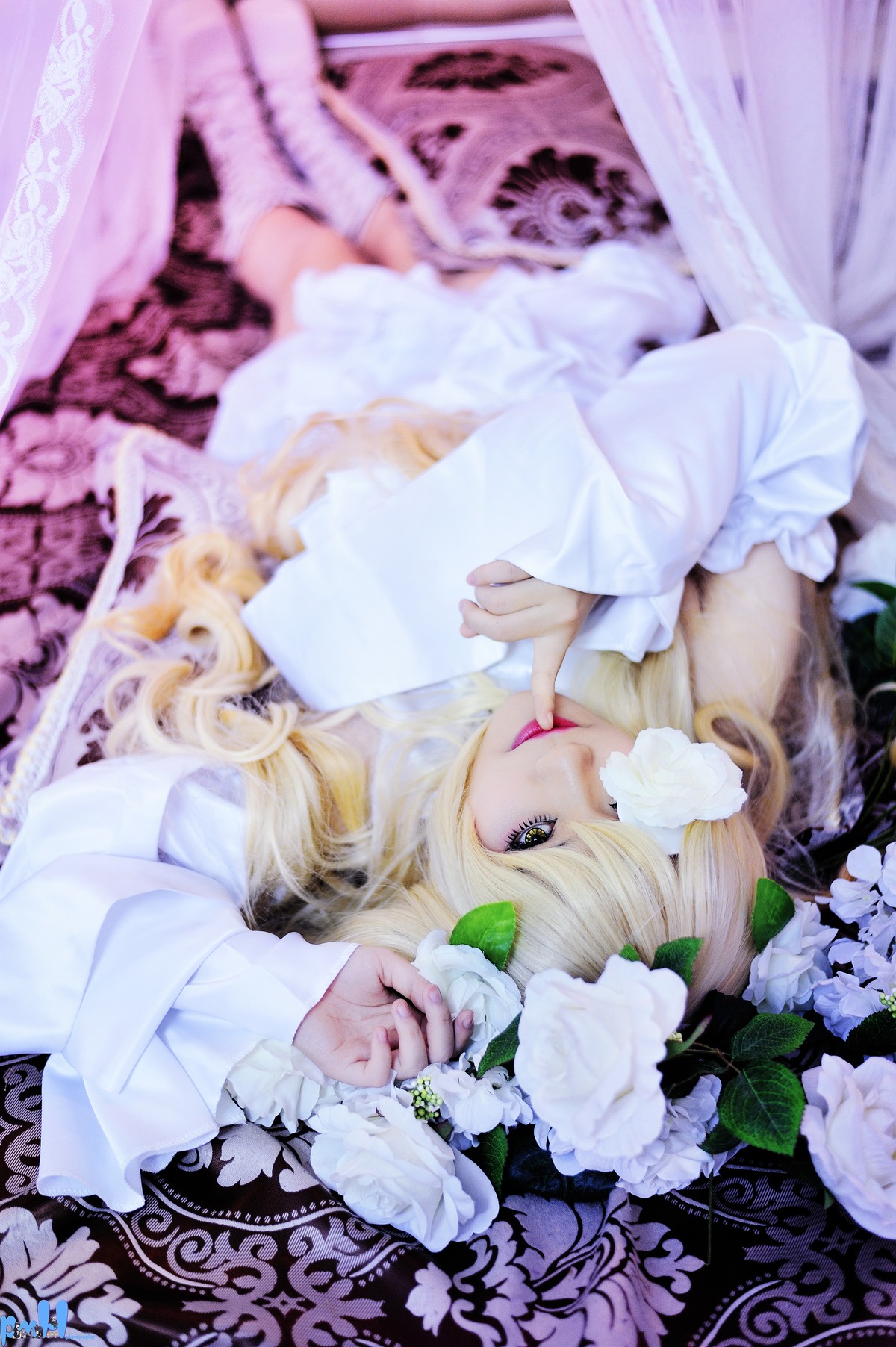 1girl bangs blonde_hair blurry blurry_background blurry_foreground depth_of_field dress flower kirakishou lips long_hair long_sleeves looking_at_viewer lying solo