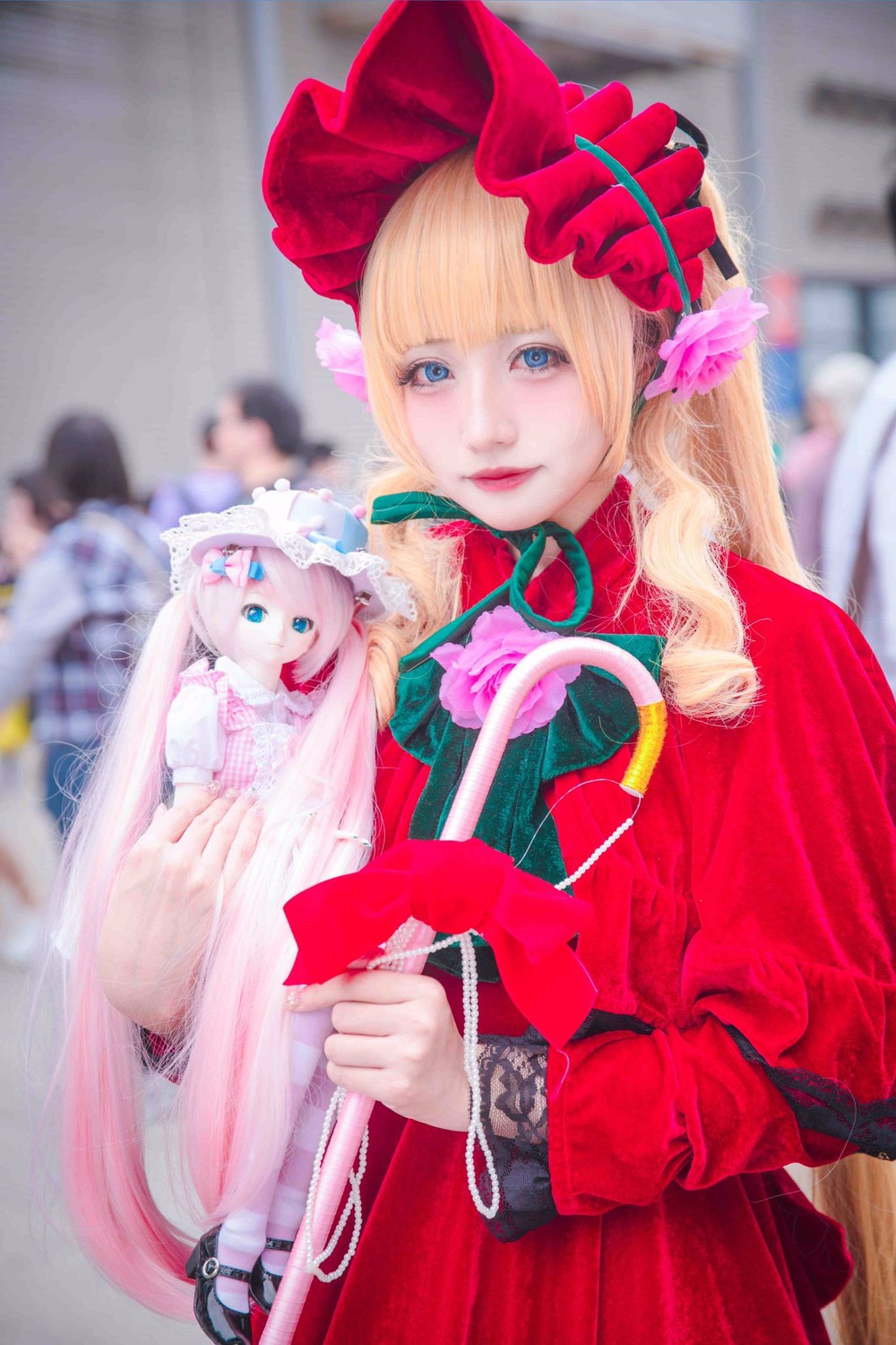 1girl blonde_hair blue_eyes blurry blurry_background blurry_foreground bow depth_of_field flower long_hair looking_at_viewer photo shinku solo