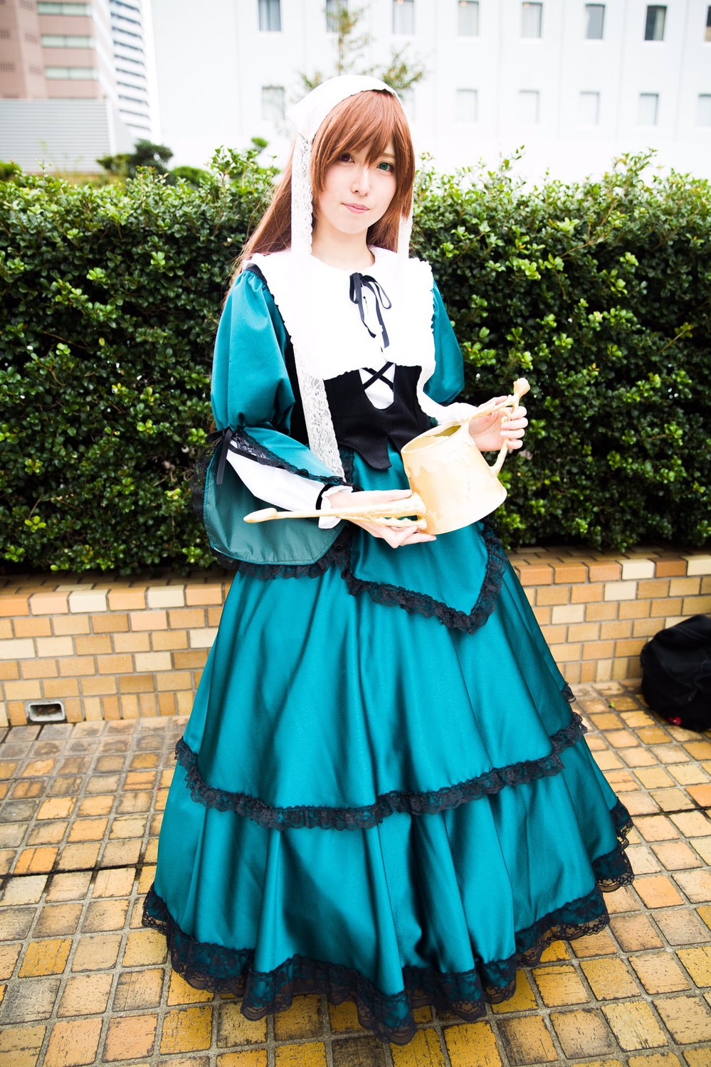 1girl blue_dress brick_wall brown_hair chain-link_fence dress fence long_hair outdoors pavement smile solo suiseiseki tile_floor tiles