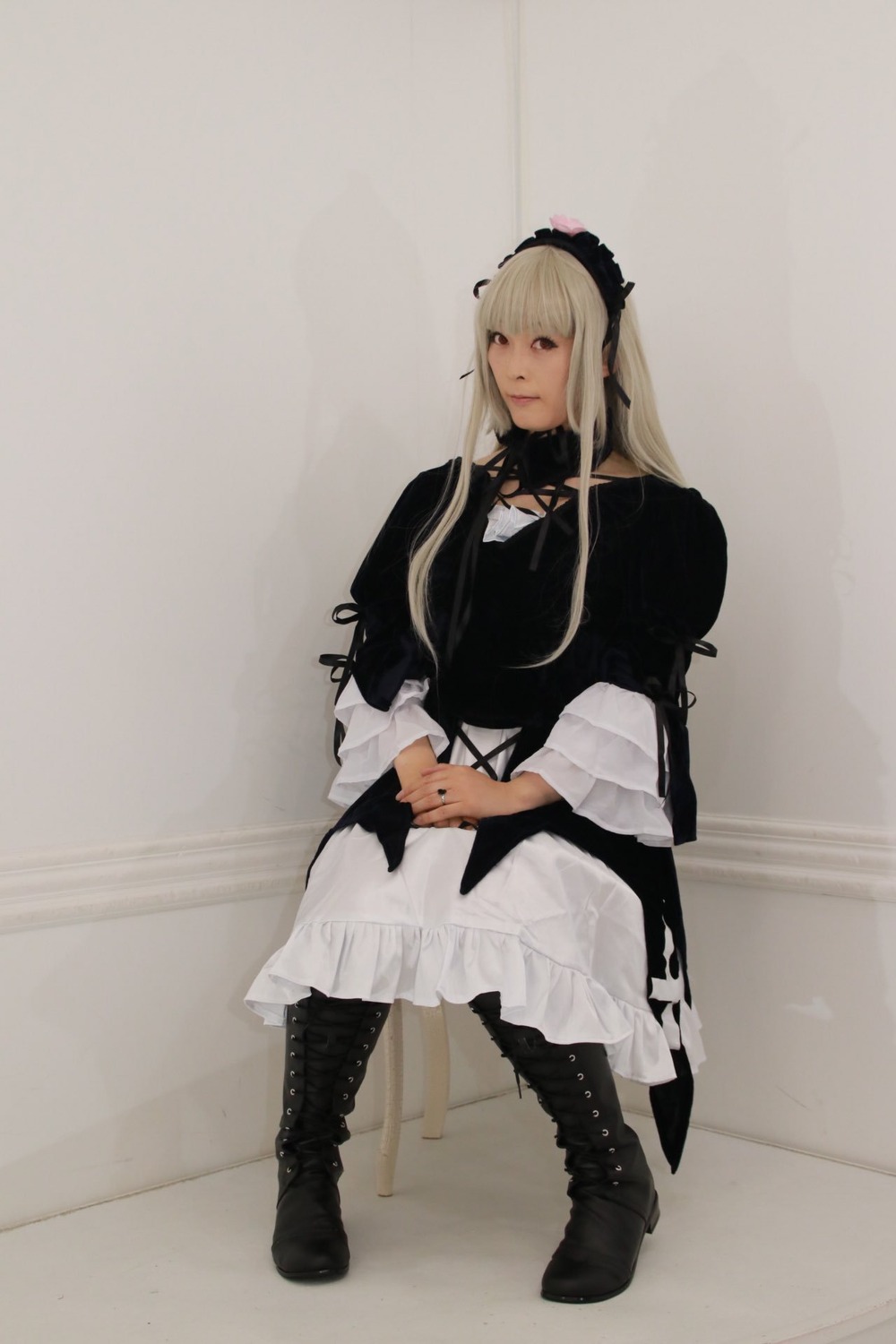 1girl black_footwear blonde_hair boots closed_mouth cross-laced_footwear dress frills full_body long_hair long_sleeves sitting solo suigintou