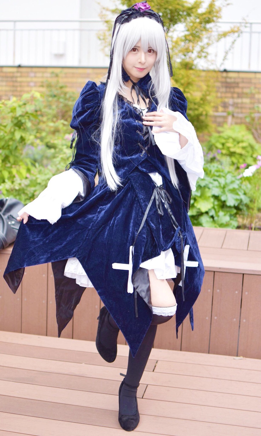 1girl black_footwear blue_dress boots dress flower full_body long_hair long_sleeves looking_at_viewer outdoors smile solo standing suigintou white_hair