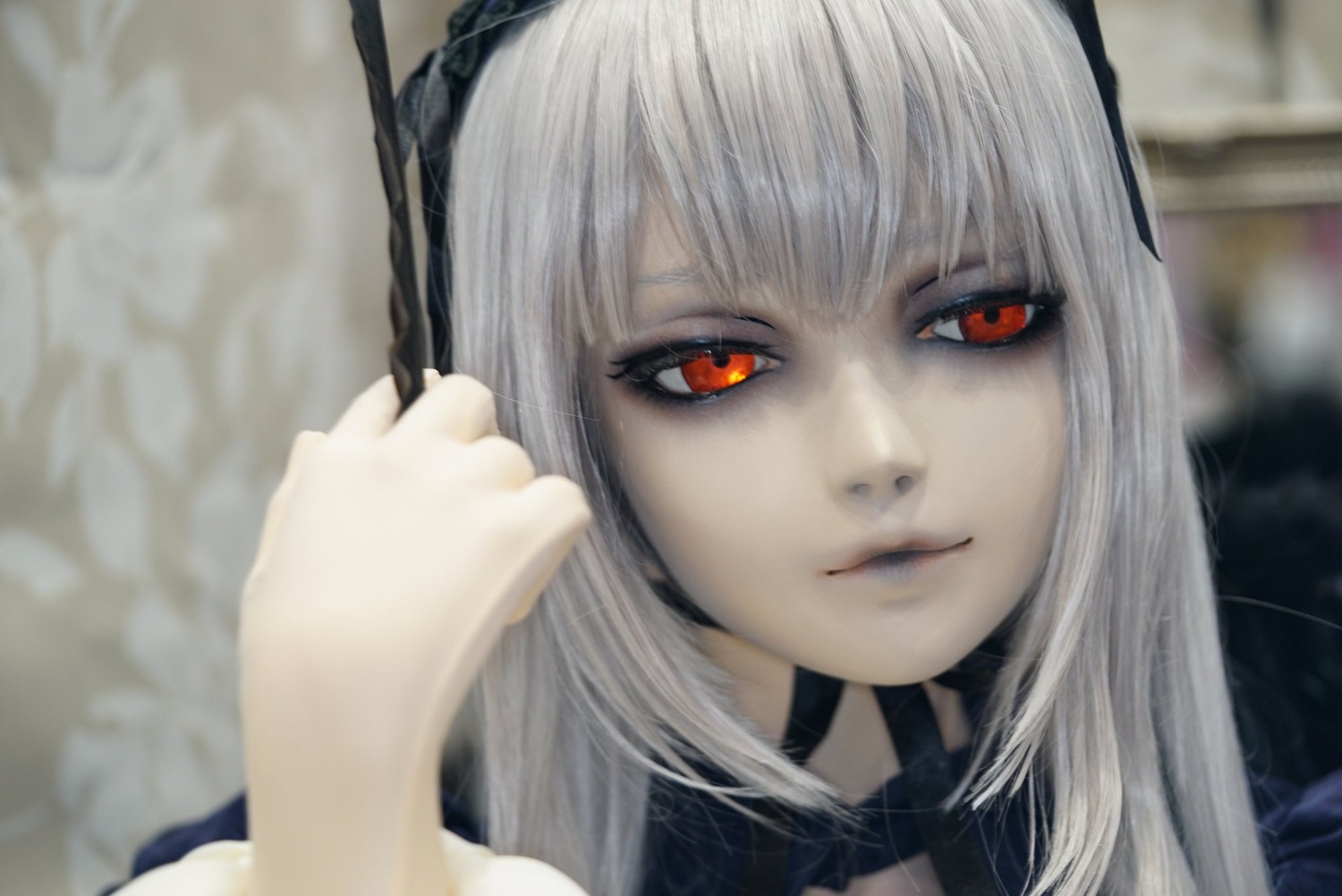 1girl bangs black_choker blurry blurry_background choker closed_mouth depth_of_field lips long_hair looking_at_viewer photo portrait red_eyes solo suigintou