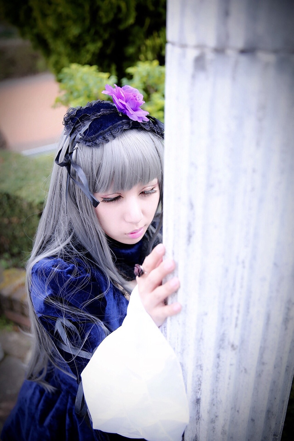 1girl bangs blurry blurry_background blurry_foreground closed_mouth depth_of_field flower lips long_hair long_sleeves nail_polish silver_hair solo suigintou