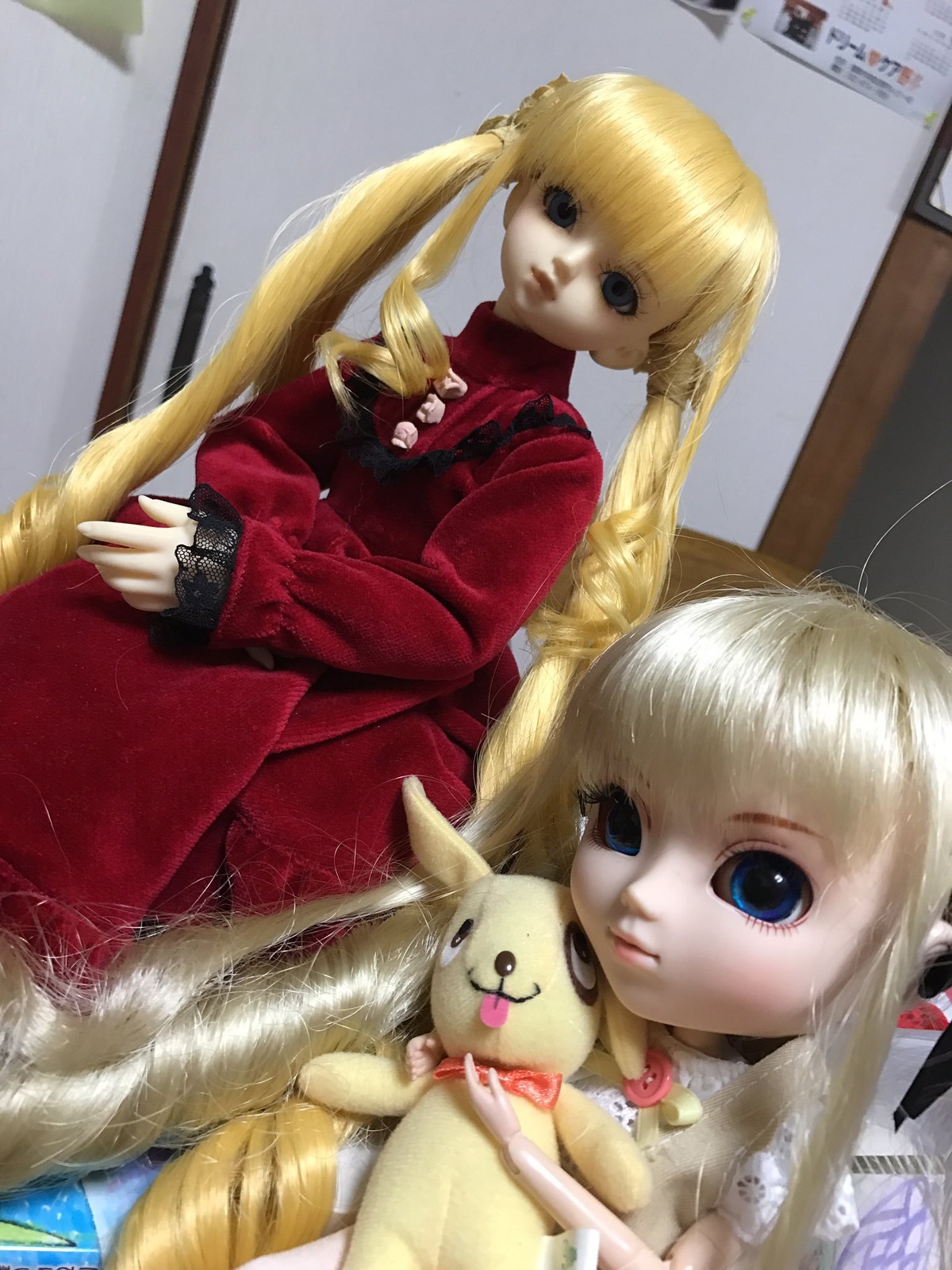 1girl bangs blonde_hair blue_eyes dog doll drill_hair long_hair long_sleeves looking_at_viewer photo red_dress shinku sitting solo stuffed_animal twin_drills twintails