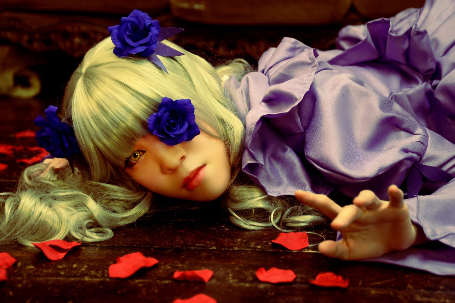 1girl barasuishou blonde_hair blue_flower blue_rose drill_hair eyepatch flower hair_ornament long_hair lying petals rose solo yellow_eyes