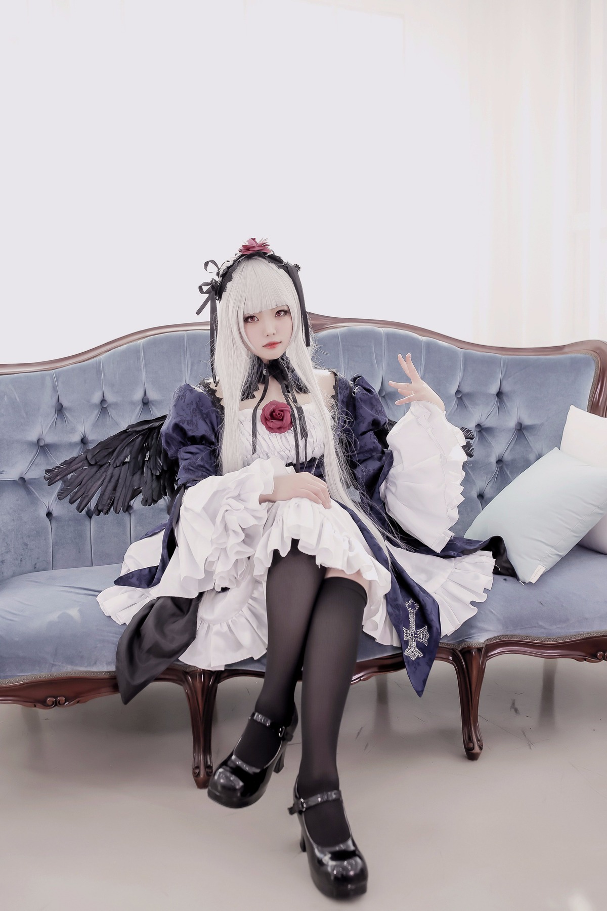 1girl bangs black_footwear black_legwear black_wings chair crossed_legs dress feathered_wings feathers flower long_hair long_sleeves sitting solo suigintou white_hair wide_sleeves wings