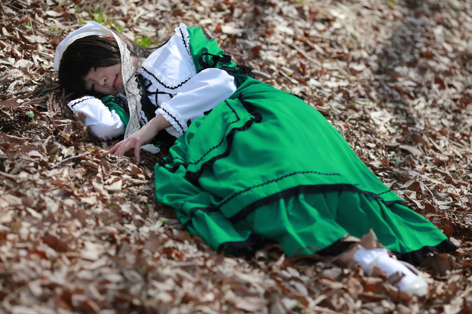 1girl black_hair blurry blurry_foreground closed_eyes depth_of_field dress frills green_dress lips long_sleeves lying photo solo suiseiseki