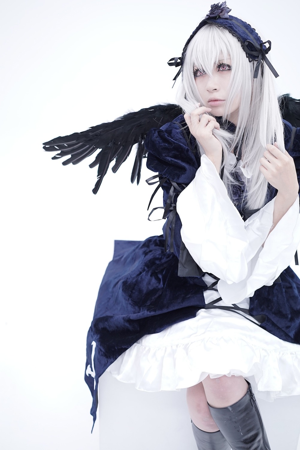 1girl black_wings boots dress feathered_wings feathers frills hairband long_hair long_sleeves looking_at_viewer ribbon silver_hair solo suigintou white_background wings