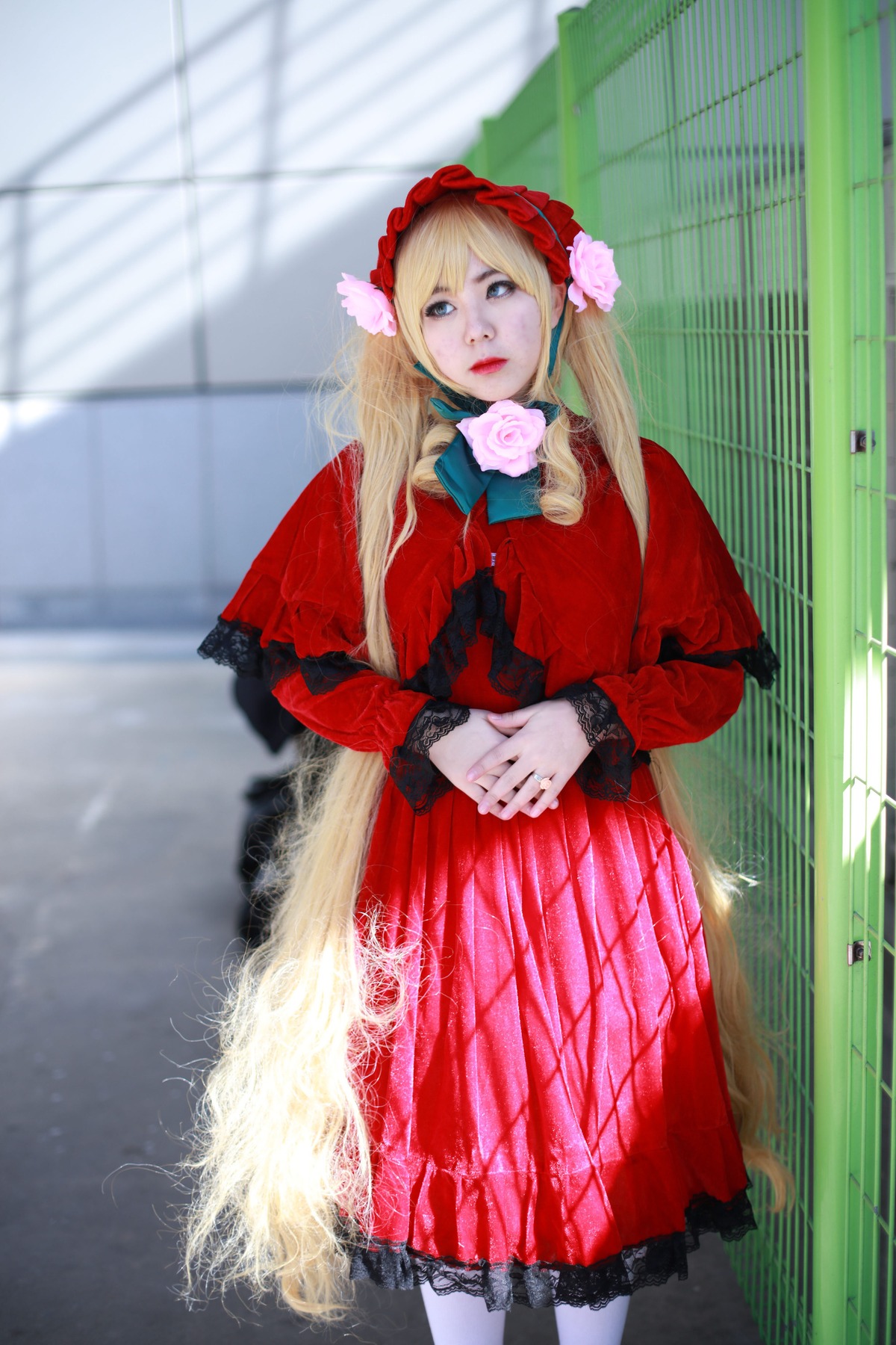 1girl blonde_hair blue_eyes blurry bonnet depth_of_field dress flower hands_together long_hair own_hands_together pantyhose photo red_dress rose shinku solo