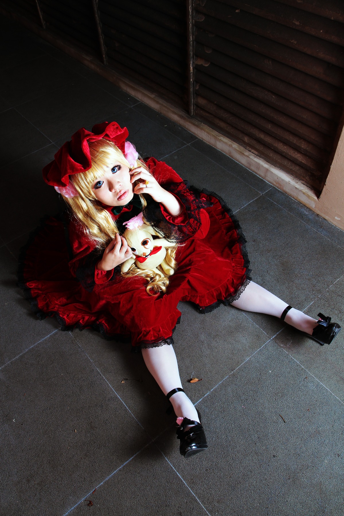 1girl blonde_hair blue_eyes bow dress frills long_hair red_dress ribbon rose shinku shoes sitting solo