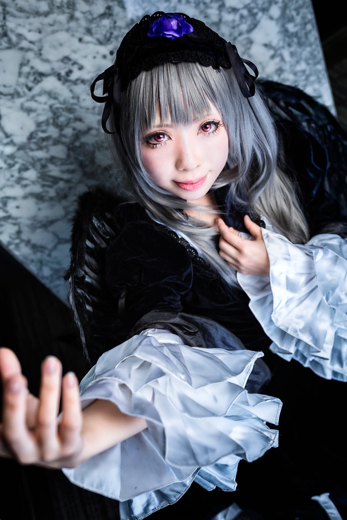 1girl bangs blunt_bangs blurry blurry_background blurry_foreground closed_mouth depth_of_field flower lips lolita_fashion long_hair long_sleeves looking_at_viewer smile solo suigintou upper_body