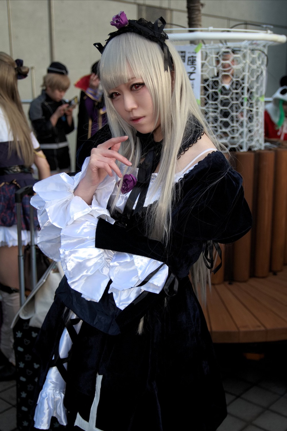 3d bangs blonde_hair blurry blurry_background depth_of_field dress frills gothic_lolita hat indoors lips lolita_fashion long_hair multiple_girls photo realistic sitting solo solo_focus suigintou