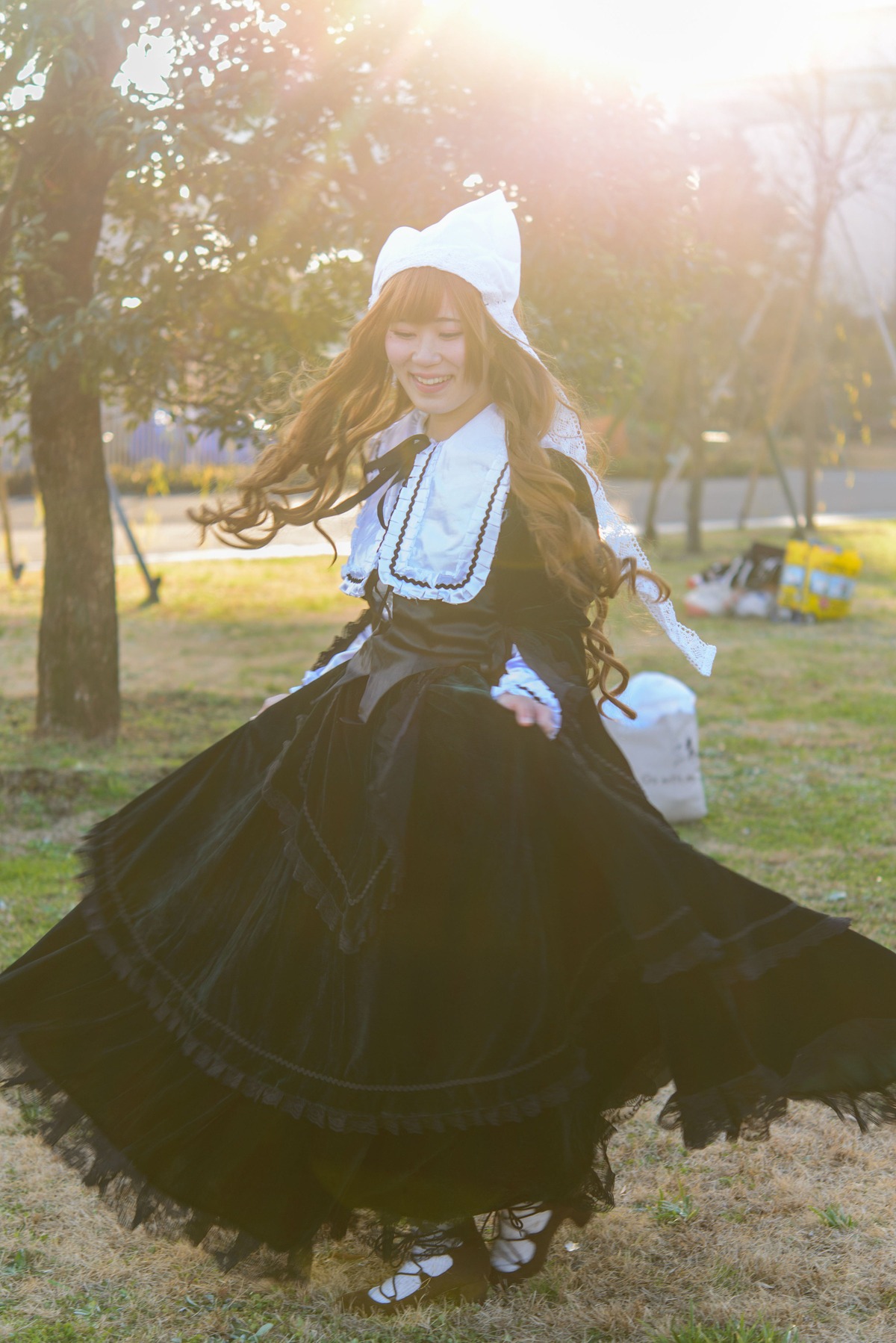 1girl blonde_hair closed_eyes dress long_hair long_sleeves outdoors smile solo standing suiseiseki tree