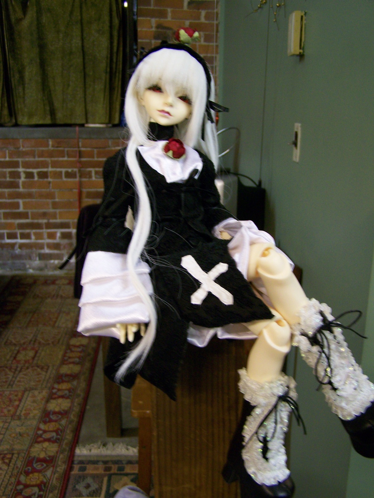 1girl 3d black_dress boots doll dress indoors long_hair long_sleeves photo sitting solo standing suigintou white_hair