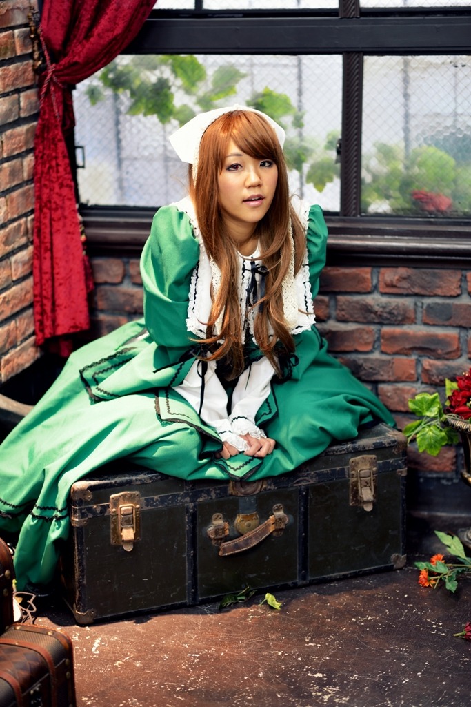 1girl bag brown_hair dress green_dress long_hair looking_at_viewer sitting solo suiseiseki suitcase window