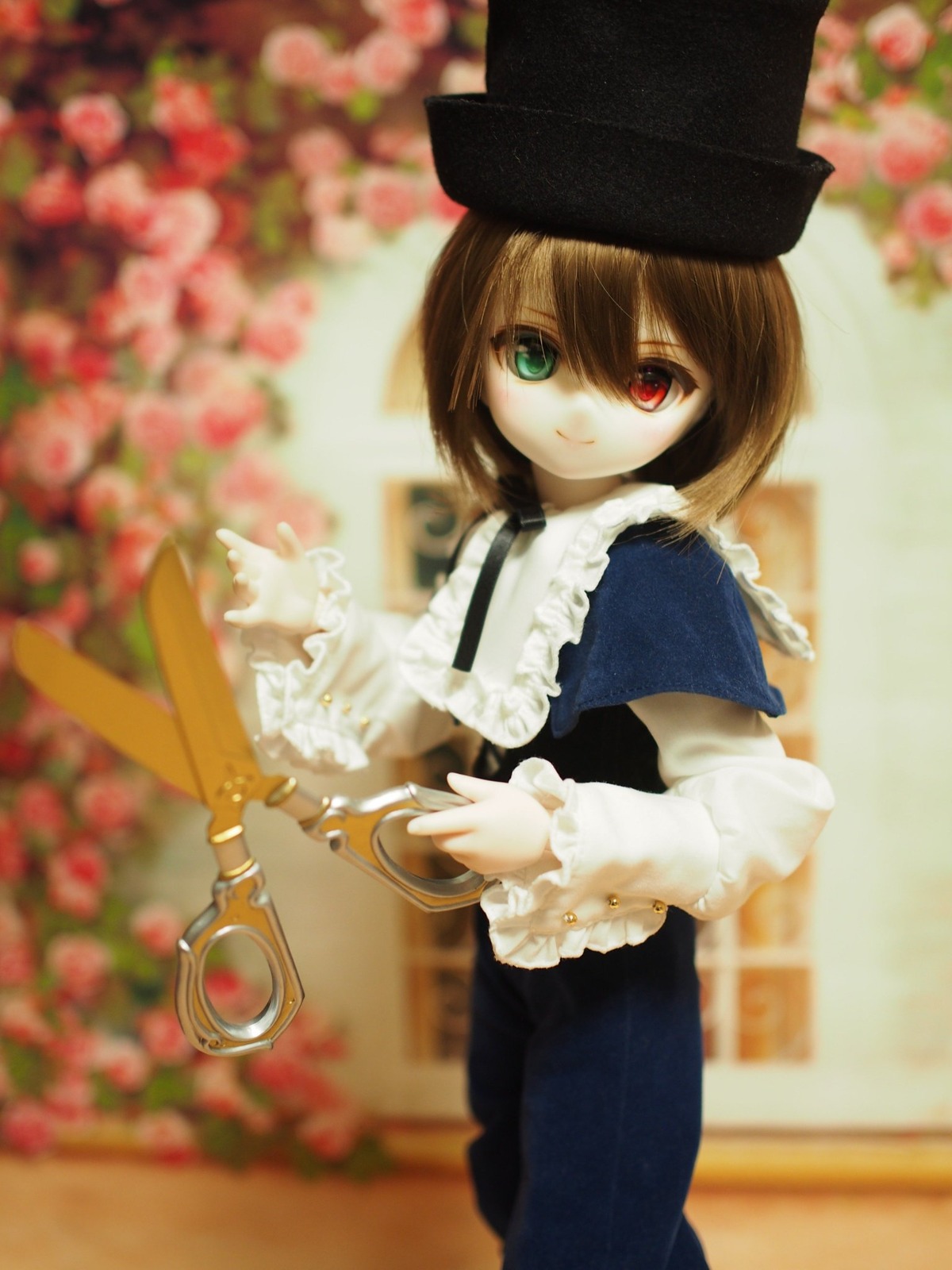 1girl blurry blurry_background blurry_foreground brown_hair depth_of_field doll dress flower frilled_shirt_collar frilled_sleeves frills hat heterochromia long_sleeves looking_at_viewer red_eyes short_hair smile solo souseiseki suiseiseki