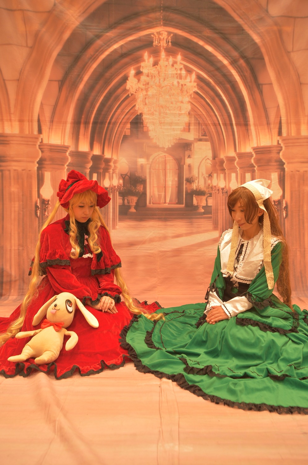 2girls blonde_hair bonnet bow braid brown_hair closed_eyes dress frills green_dress hair_bow indoors long_hair long_sleeves multiple_cosplay multiple_girls sitting stuffed_animal tagme very_long_hair