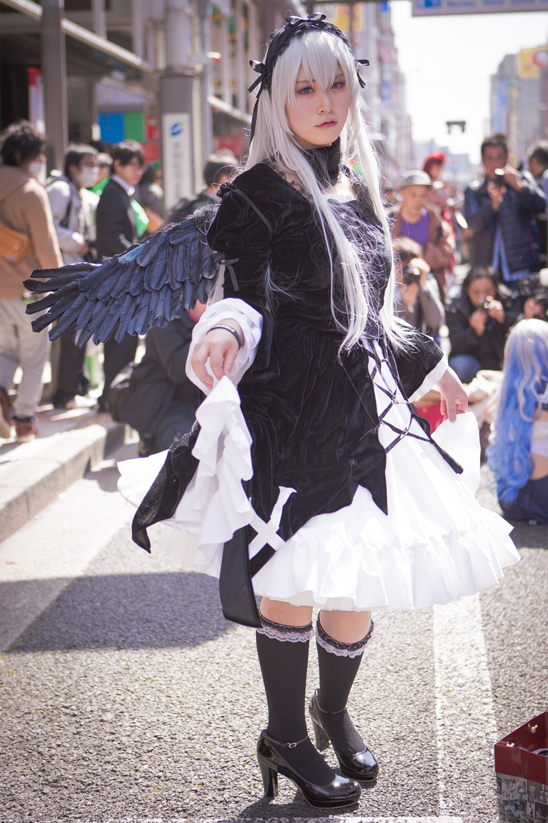 1girl argyle black_footwear black_legwear blurry blurry_background blurry_foreground boots checkered checkered_floor depth_of_field high_heels long_hair looking_at_viewer photo solo solo_focus standing suigintou tile_floor tiles wings