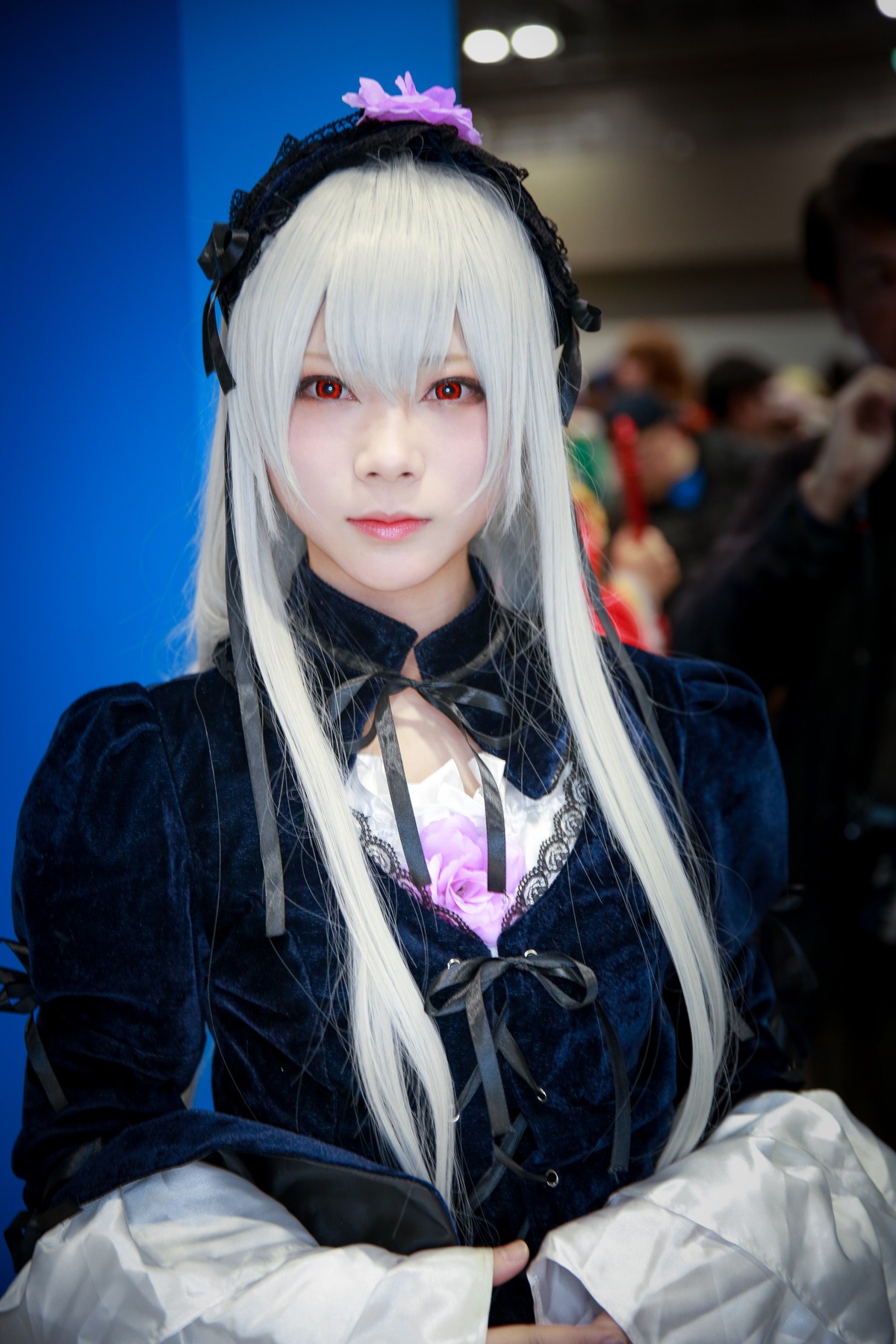 1girl blurry blurry_background depth_of_field dress flower gothic_lolita hairband lips long_hair long_sleeves looking_at_viewer red_eyes ribbon solo suigintou