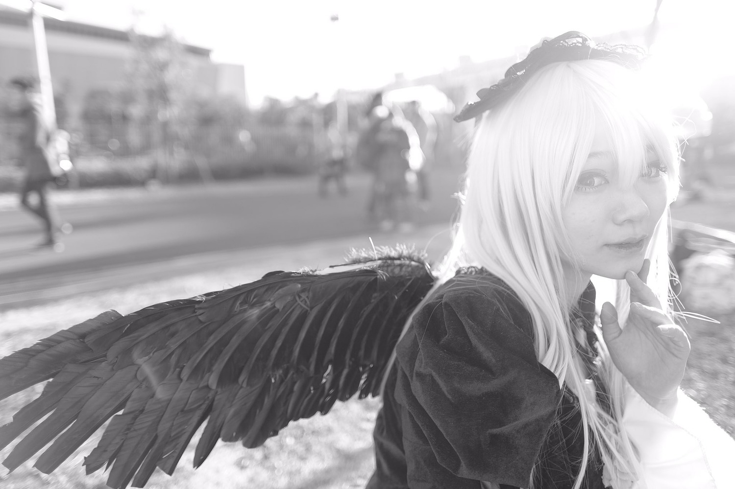 1girl angel angel_wings bird bird_wings blurry blurry_background closed_mouth depth_of_field feathered_wings greyscale long_hair long_sleeves monochrome outdoors solo suigintou upper_body wings