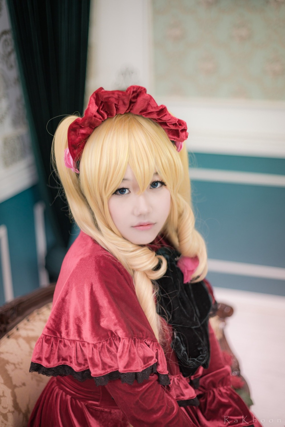 1girl blonde_hair blue_eyes blurry blurry_background capelet depth_of_field dress drill_hair flower lips long_hair looking_at_viewer photo red_dress shinku solo