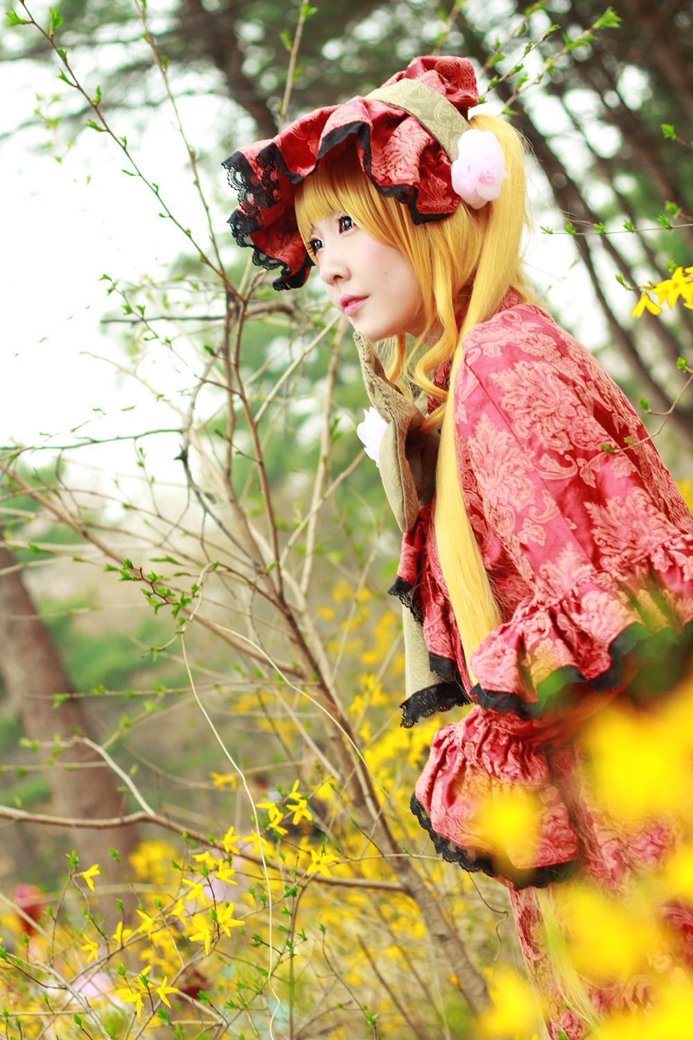 1girl blonde_hair blue_eyes blurry depth_of_field dress flower lips long_hair realistic shinku sitting solo