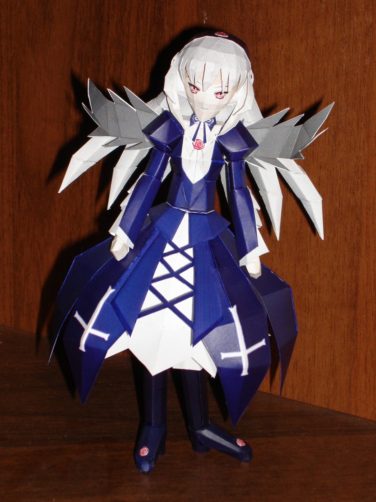 1girl bangs closed_mouth doll dress full_body long_sleeves looking_at_viewer red_eyes solo standing suigintou white_hair wings