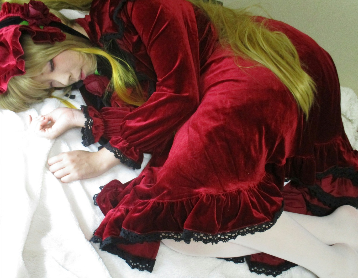 1girl blonde_hair bonnet closed_eyes dress flower frills lace long_hair long_sleeves lying on_side realistic red_dress rose shinku sleeping solo