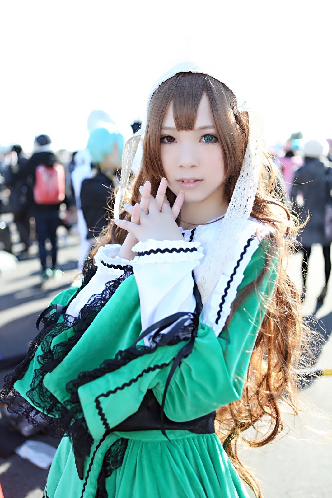 1girl blue_eyes blurry blurry_background blurry_foreground brown_hair chain depth_of_field dress green_dress lace lips long_hair looking_at_viewer solo suiseiseki