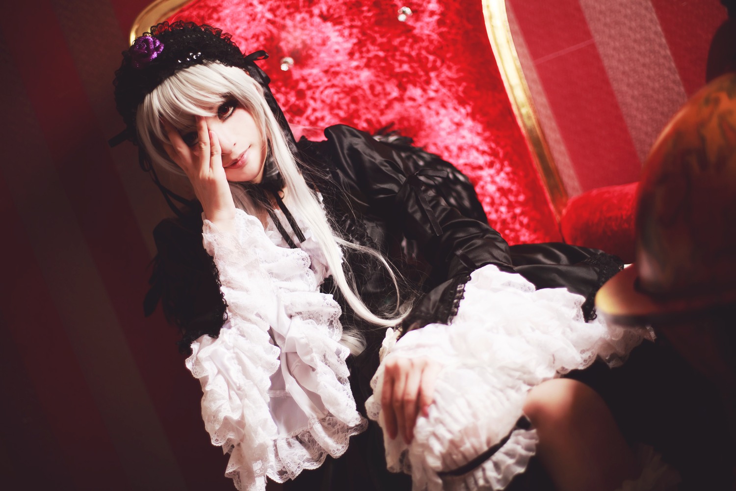 1girl black_dress dress frills lips long_hair long_sleeves sitting solo suigintou white_hair