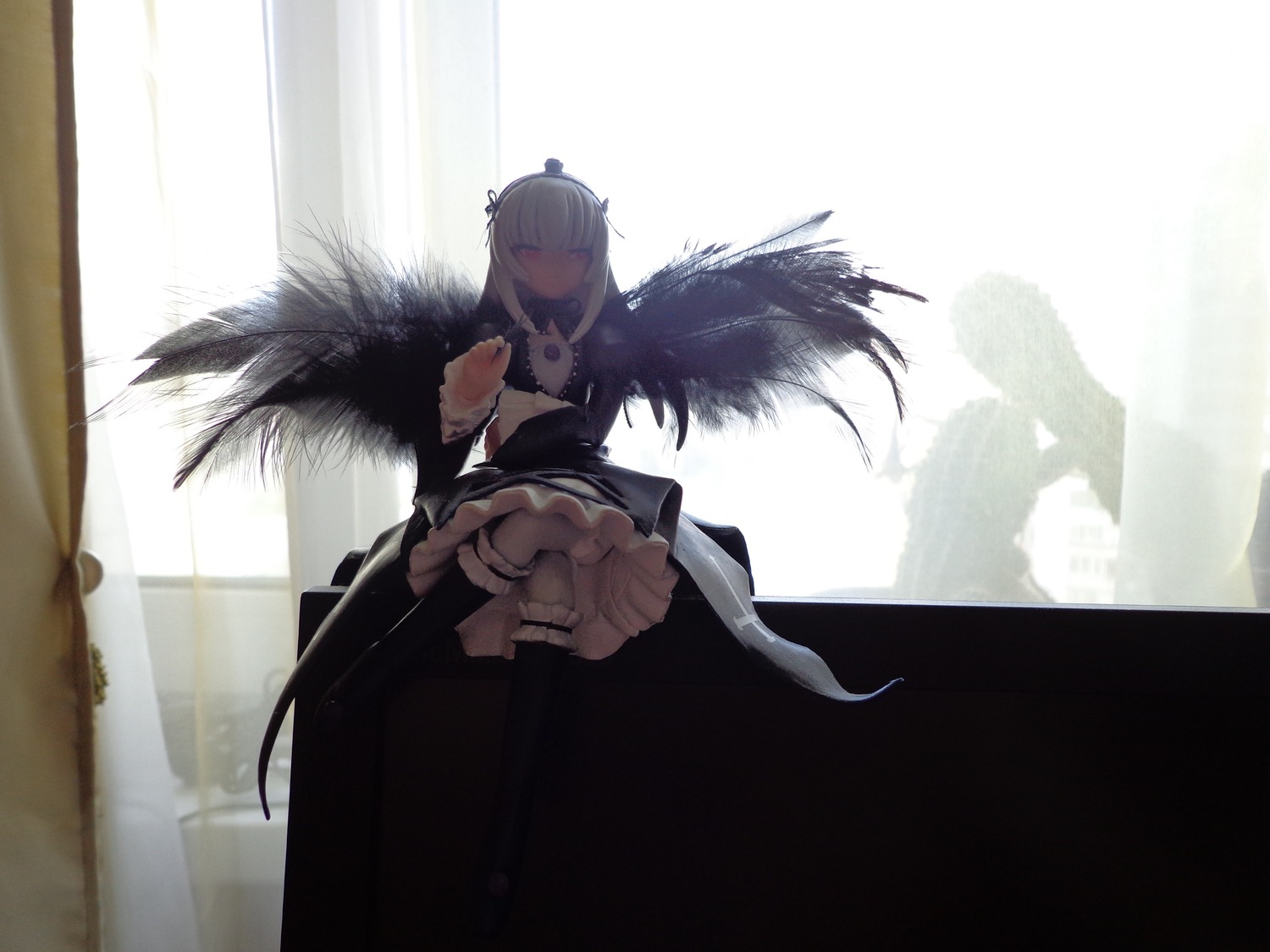 1girl bangs breasts closed_mouth doll dress feathers frills from_below holding long_hair solo standing suigintou wings