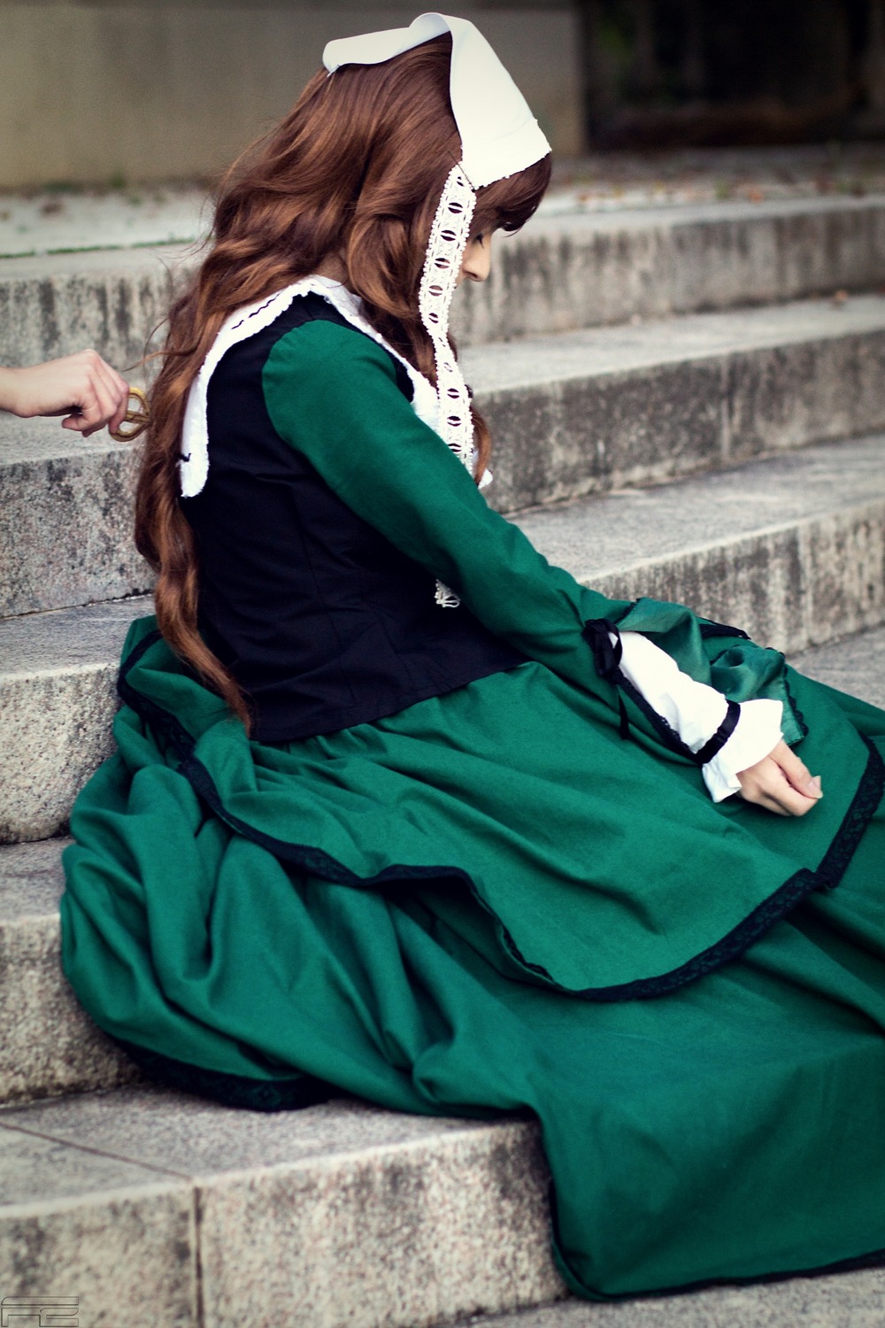 blurry brown_hair depth_of_field dress green_dress long_sleeves sitting solo suiseiseki