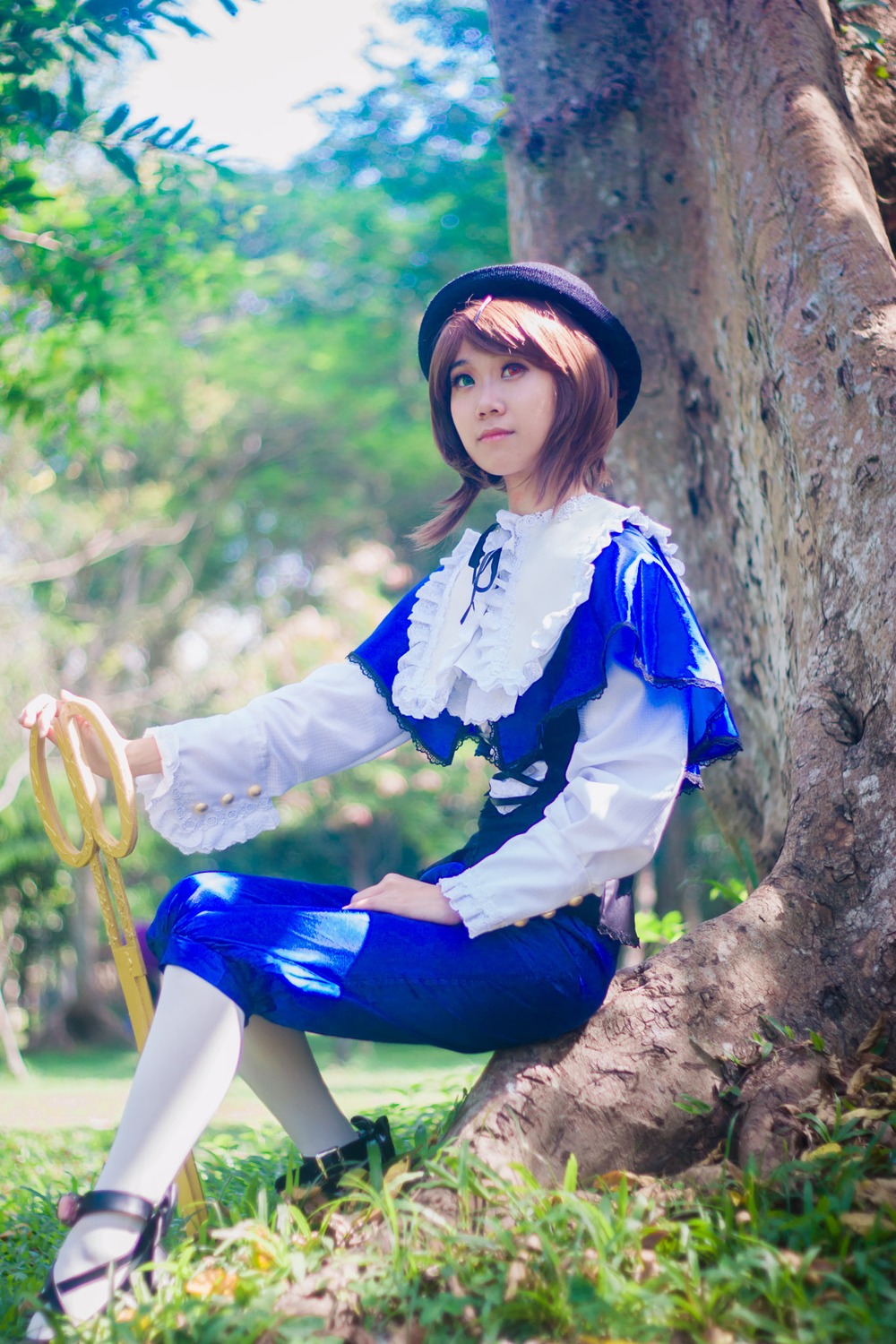 1girl blurry brown_hair day depth_of_field dress grass hat lips long_sleeves outdoors pants realistic sitting solo souseiseki tree white_legwear