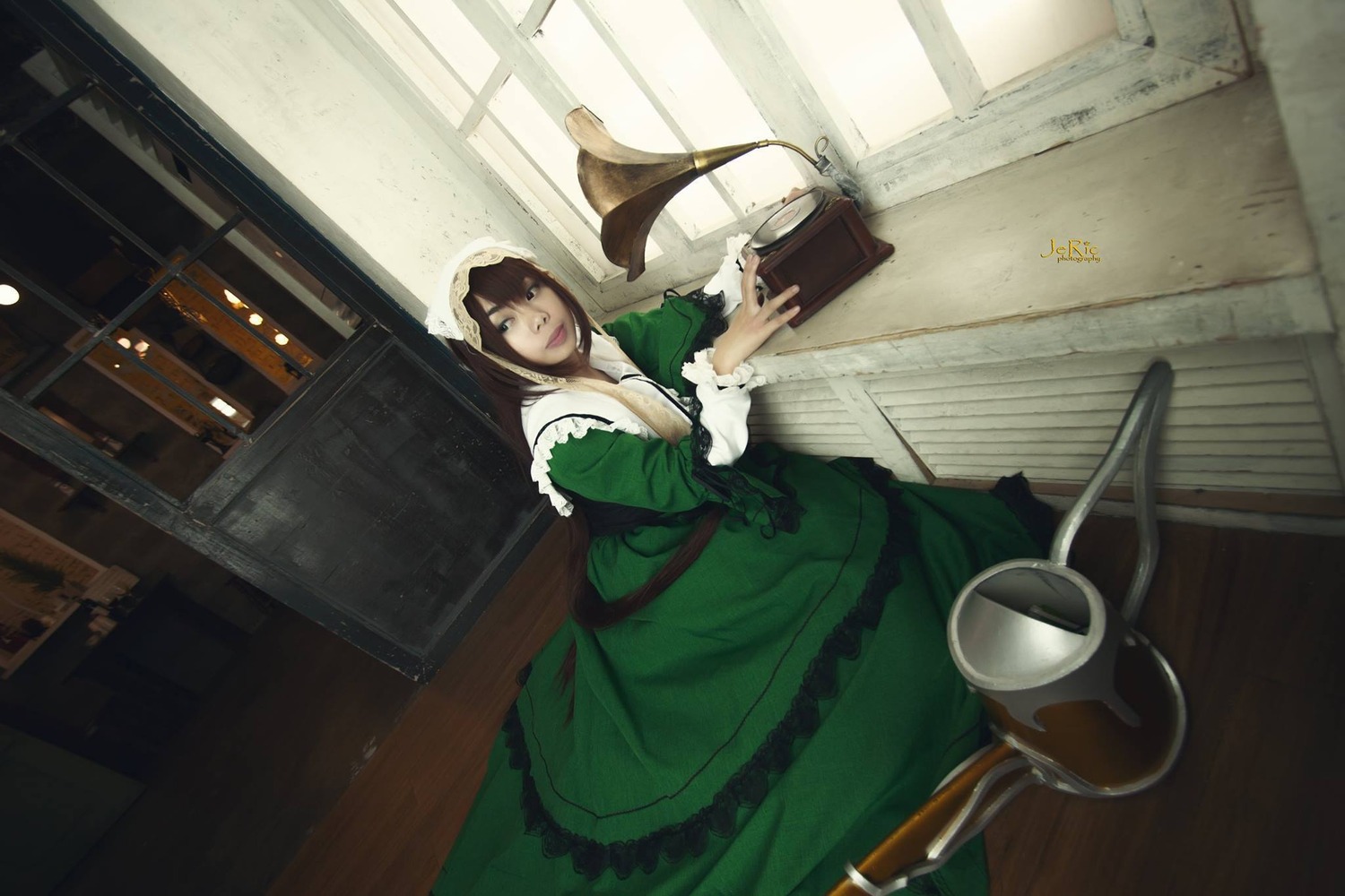 1girl apron book brown_hair dress frills green_dress indoors long_sleeves looking_at_viewer sitting solo suiseiseki